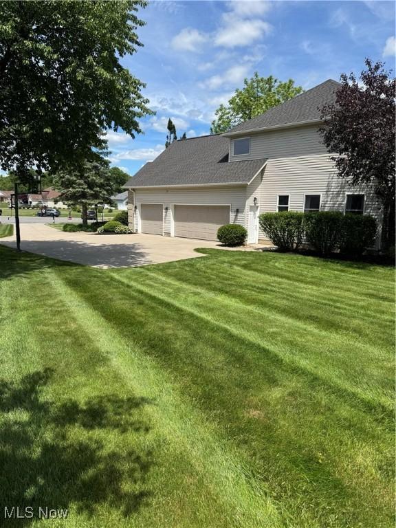 3130 Hollybrook Ln, Mogadore, OH 44260 - view of front of property with a front yard, a garage, and driveway