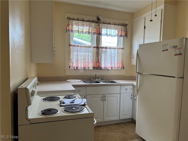 1733 E 47th St, Ashtabula, OH 44004 - kitchen with white appliances, a sink, white cabinetry, and light countertops