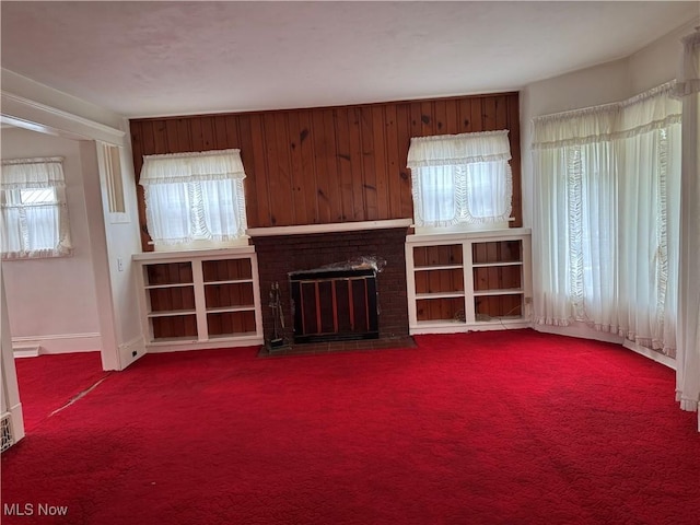 1733 E 47th St, Ashtabula, OH 44004 - unfurnished living room featuring healthy amount of natural light, a brick fireplace, and carpet flooring