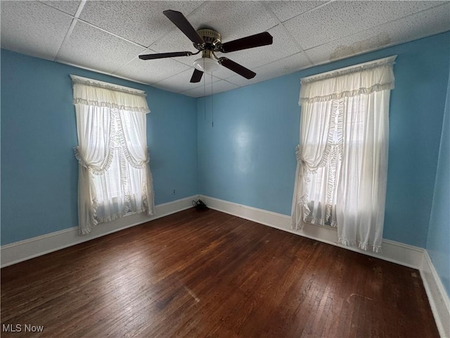 1733 E 47th St, Ashtabula, OH 44004 - unfurnished room featuring a drop ceiling, plenty of natural light, wood-type flooring, a ceiling fan, and baseboards