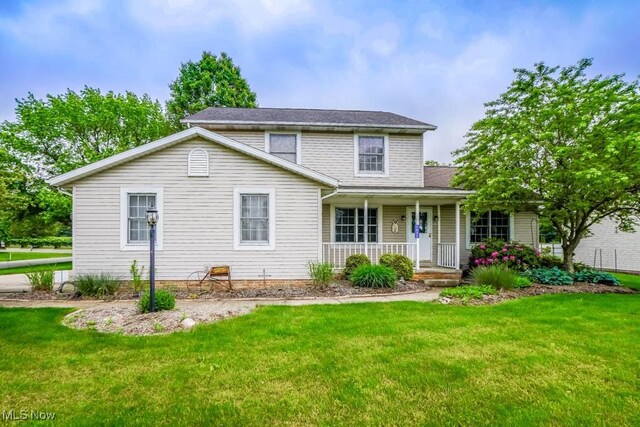 1632 Schneider St NW, North Canton, OH 44720 - traditional home with a porch and a front yard