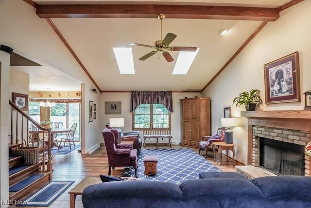 1632 Schneider St NW, North Canton, OH 44720 - living area with plenty of natural light, ceiling fan, a fireplace, wood finished floors, and ornamental molding