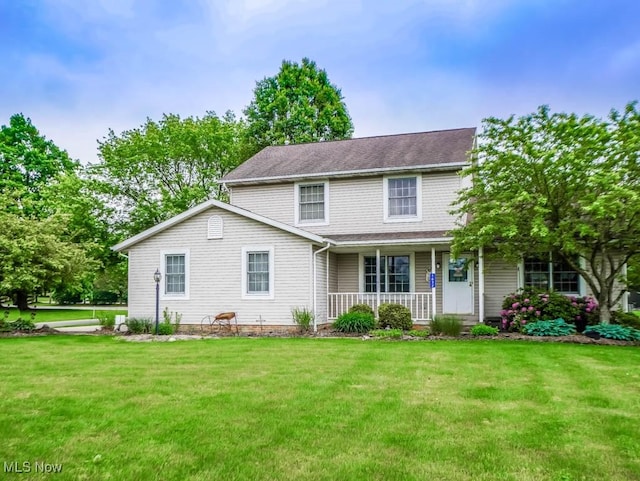 1632 Schneider St NW, North Canton, OH 44720 - traditional-style home with a porch, a front yard, and a shingled roof