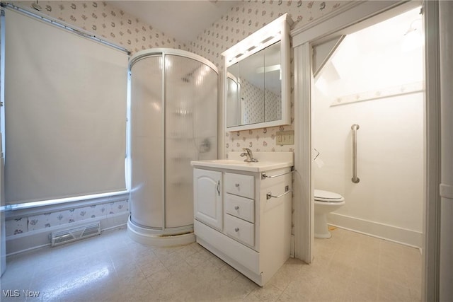 113 Lincoln Ct, Elyria, OH 44035 - bathroom with wallpapered walls, a stall shower, vanity, toilet, and baseboards