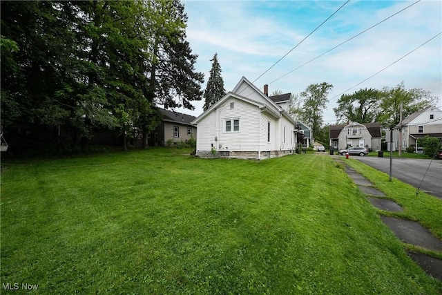 113 Lincoln Ct, Elyria, OH 44035 - view of property exterior with a yard and a chimney