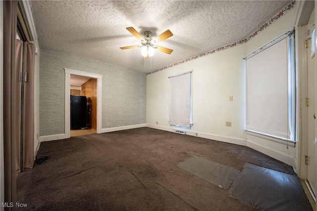 113 Lincoln Ct, Elyria, OH 44035 - carpeted empty room with baseboards, a textured ceiling, a ceiling fan, and wallpapered walls