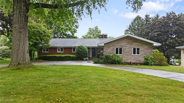 4616 Frazer Ave NW, Canton, OH 44709 - ranch-style house with a chimney, a front yard, stone siding, and curved driveway