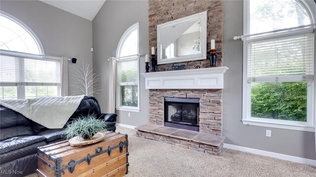 284 Kaylee Dr, Wadsworth, OH 44281 - carpeted living room with lofted ceiling, healthy amount of natural light, a fireplace, and baseboards