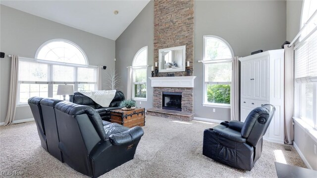 284 Kaylee Dr, Wadsworth, OH 44281 - living area featuring high vaulted ceiling, light carpet, a fireplace, and baseboards