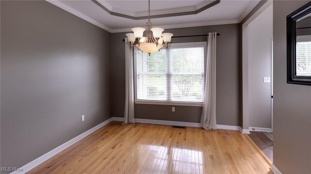284 Kaylee Dr, Wadsworth, OH 44281 - spare room with light wood finished floors, a chandelier, baseboards, ornamental molding, and a tray ceiling