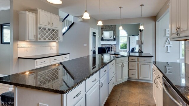 284 Kaylee Dr, Wadsworth, OH 44281 - kitchen featuring dishwasher, a sink, backsplash, white cabinets, and a fireplace