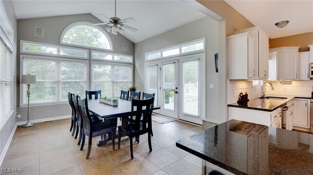 284 Kaylee Dr, Wadsworth, OH 44281 - dining room with vaulted ceiling, a ceiling fan, light tile patterned floors, and baseboards