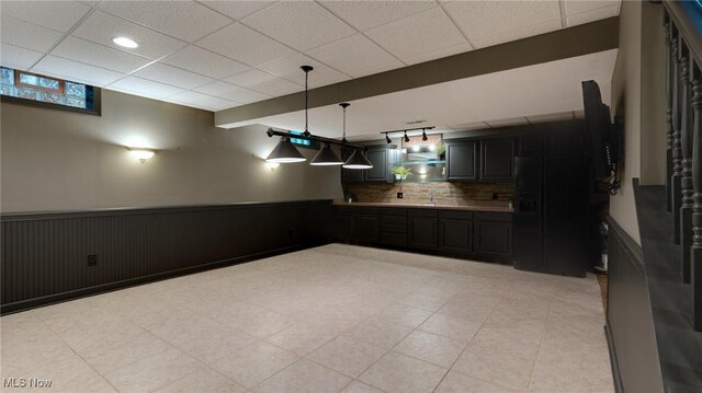 284 Kaylee Dr, Wadsworth, OH 44281 - kitchen featuring black fridge with ice dispenser, a wainscoted wall, decorative backsplash, a paneled ceiling, and dark cabinetry