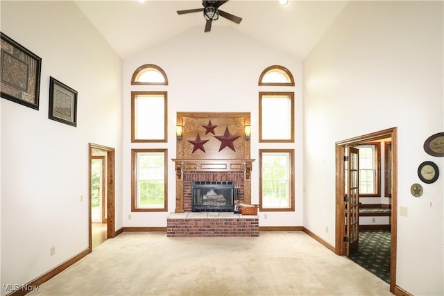 5280 Kapok Dr, Medina, OH 44256 - unfurnished living room with high vaulted ceiling, carpet, baseboards, a brick fireplace, and ceiling fan