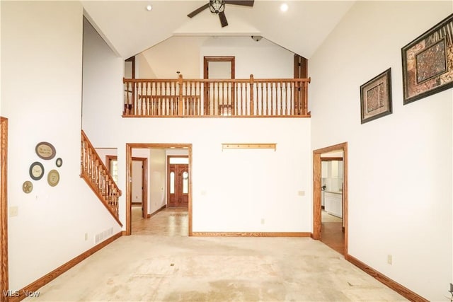 5280 Kapok Dr, Medina, OH 44256 - unfurnished living room with high vaulted ceiling, carpet flooring, a ceiling fan, baseboards, and stairs
