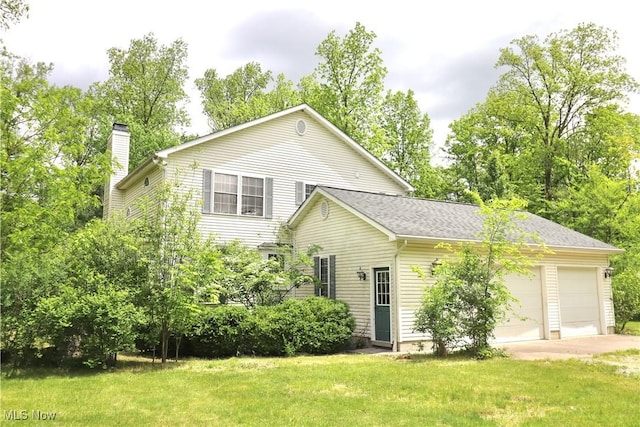 5280 Kapok Dr, Medina, OH 44256 - view of front of house with a chimney, concrete driveway, a garage, and a front lawn