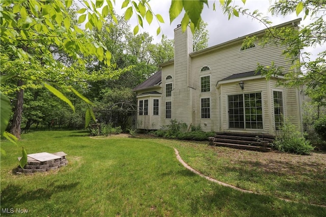 5280 Kapok Dr, Medina, OH 44256 - rear view of house with a lawn and a chimney