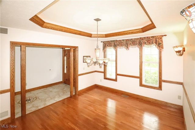 5280 Kapok Dr, Medina, OH 44256 - unfurnished dining area with wood finished floors, a tray ceiling, and baseboards