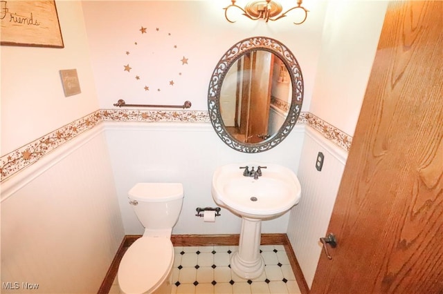 5280 Kapok Dr, Medina, OH 44256 - half bathroom with a wainscoted wall and toilet