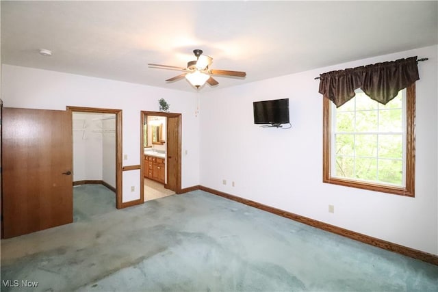 5280 Kapok Dr, Medina, OH 44256 - unfurnished bedroom with light carpet, baseboards, a spacious closet, a closet, and a ceiling fan