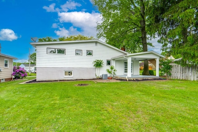 1924 Tiffany Dr NE, Warren, OH 44483 - back of house with central AC and a patio