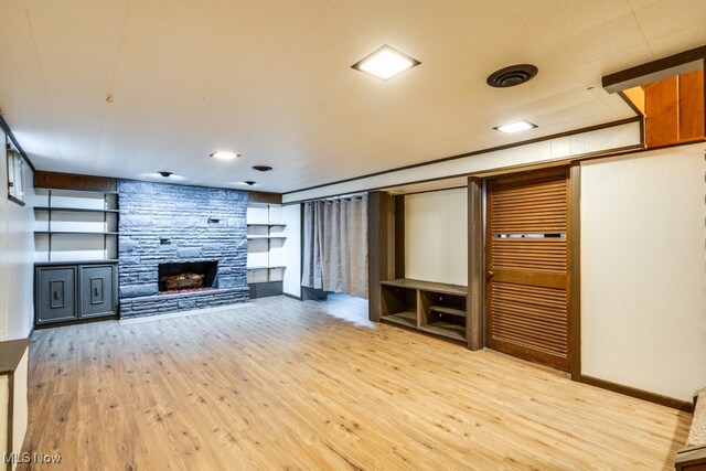 1924 Tiffany Dr NE, Warren, OH 44483 - unfurnished living room with wood finished floors, a fireplace, and baseboards