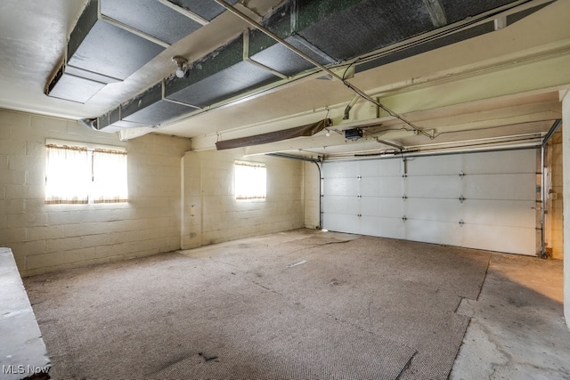 1924 Tiffany Dr NE, Warren, OH 44483 - garage featuring a garage door opener and concrete block wall