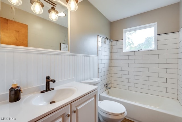 1924 Tiffany Dr NE, Warren, OH 44483 - bathroom with toilet, vanity, shower / bathtub combination, and a wainscoted wall