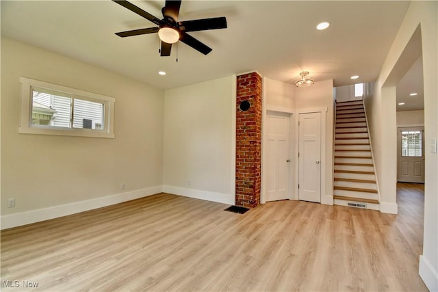 205 W Slingluff Ave, Dover, OH 44622 - unfurnished living room featuring stairway, light wood-style flooring, baseboards, and recessed lighting