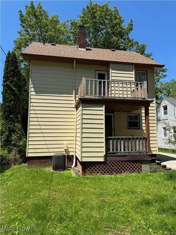 28100 Gilchrist Dr, Euclid, OH 44132 - back of property featuring a balcony, covered porch, a yard, and a chimney
