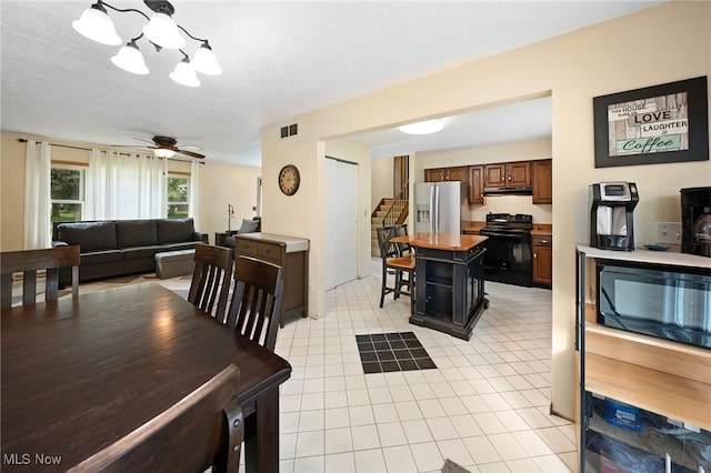 36304 Westfield Dr, North Ridgeville, OH 44039 - dining room featuring a chandelier, ceiling fan, and light tile patterned floors
