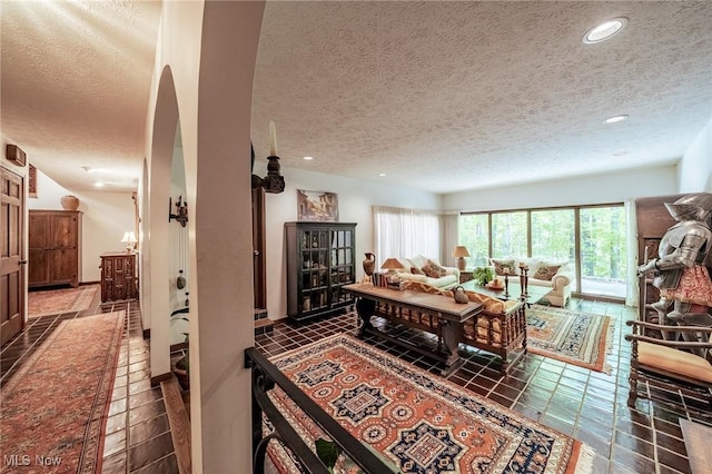 10576 Hemlock Ridge Dr, Chardon, OH 44024 - living room with a textured ceiling, recessed lighting, arched walkways, and tile patterned flooring