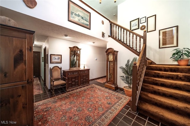 10576 Hemlock Ridge Dr, Chardon, OH 44024 - stairway featuring tile patterned flooring and a towering ceiling