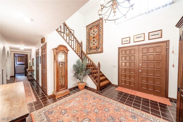 10576 Hemlock Ridge Dr, Chardon, OH 44024 - entrance foyer featuring tile patterned floors, arched walkways, stairs, and a chandelier