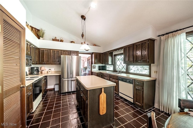 10576 Hemlock Ridge Dr, Chardon, OH 44024 - kitchen with appliances with stainless steel finishes, a center island, light countertops, lofted ceiling, and dark brown cabinetry