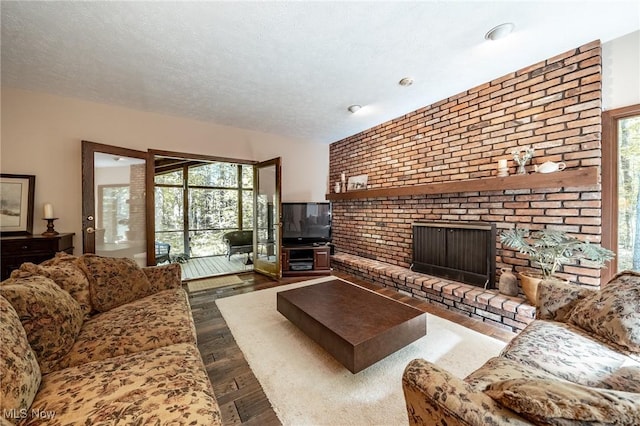 10576 Hemlock Ridge Dr, Chardon, OH 44024 - living room with a brick fireplace, dark wood-style floors, and a textured ceiling