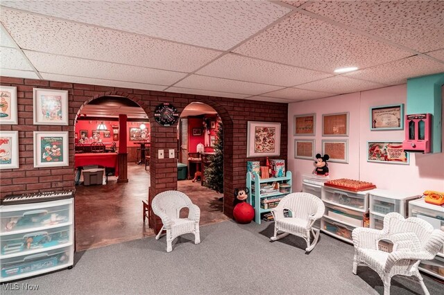 10576 Hemlock Ridge Dr, Chardon, OH 44024 - game room with a drop ceiling, arched walkways, and brick wall