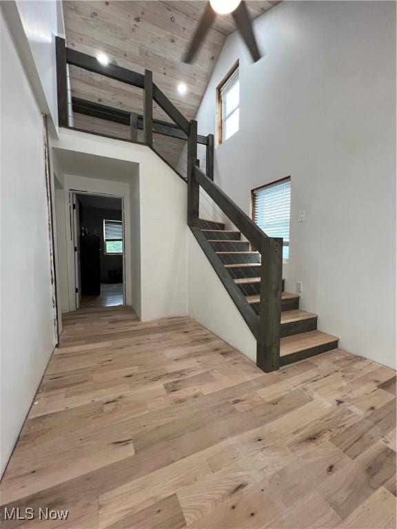 26938 County Rd 1, Coshocton, OH 43812 - stairway featuring wood finished floors, high vaulted ceiling, a ceiling fan, and beamed ceiling
