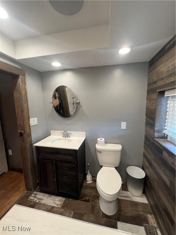 26938 County Rd 1, Coshocton, OH 43812 - bathroom with vanity, wooden walls, wood finished floors, and recessed lighting
