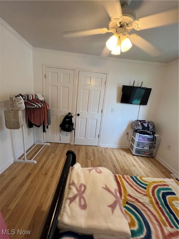 26938 County Rd 1, Coshocton, OH 43812 - bedroom with light wood-type flooring, crown molding, and ceiling fan