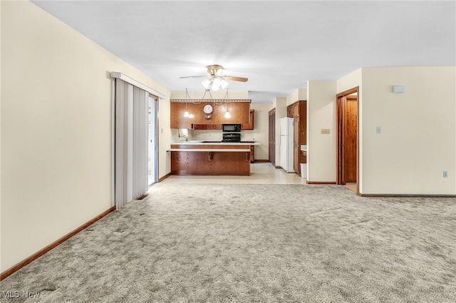 14031405 Frank Dr, Wooster, OH 44691 - kitchen featuring black microwave, ceiling fan, a peninsula, open floor plan, and freestanding refrigerator