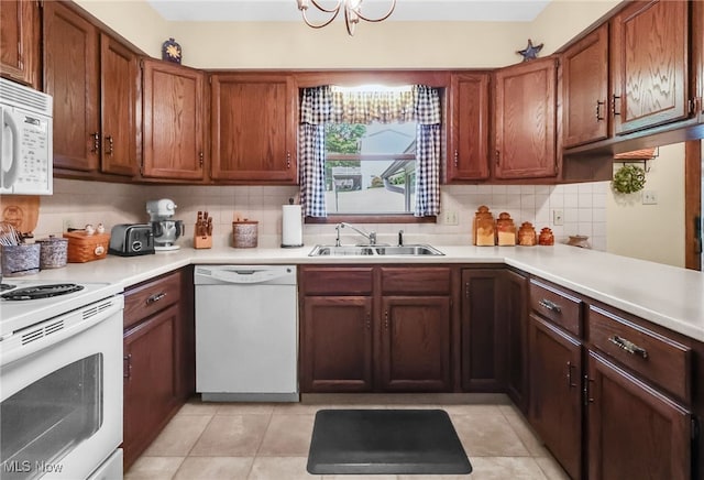 14031405 Frank Dr, Wooster, OH 44691 - kitchen with white appliances, a sink, light countertops, backsplash, and brown cabinetry