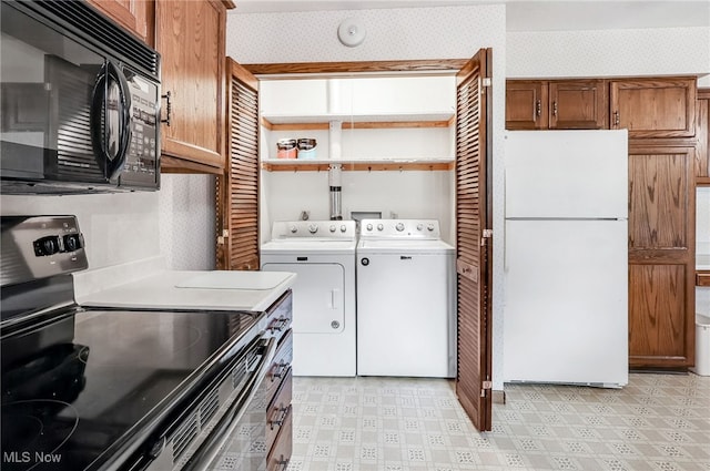 14031405 Frank Dr, Wooster, OH 44691 - kitchen featuring freestanding refrigerator, stainless steel electric range, black microwave, separate washer and dryer, and wallpapered walls