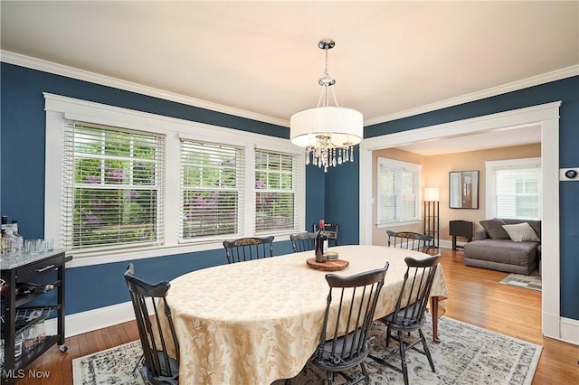 4531 Ardendale Rd, South Euclid, OH 44121 - dining area featuring a chandelier, crown molding, baseboards, and wood finished floors