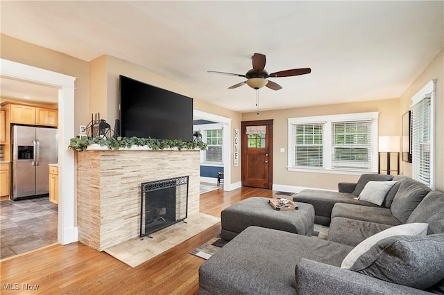4531 Ardendale Rd, South Euclid, OH 44121 - living area featuring a ceiling fan, light wood-style floors, a fireplace, and baseboards
