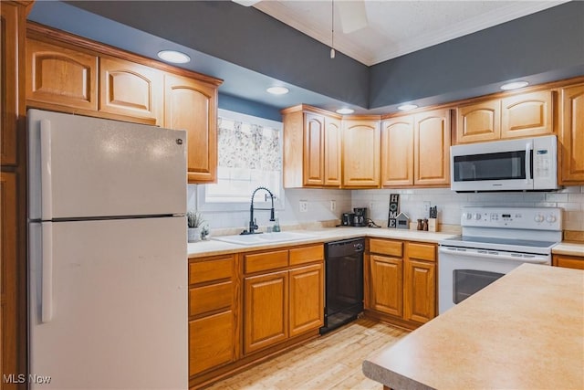 kitchen with white appliances, a sink, light wood-style flooring, crown molding, and tasteful backsplash