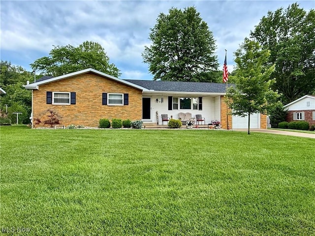 52 Woodlawn Ave, Belpre, OH 45714 - ranch-style home with a front lawn, brick siding, an attached garage, and driveway