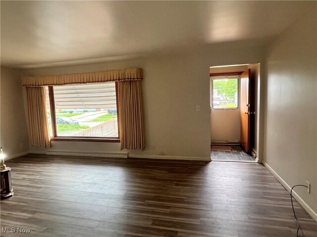 213 Kenmore Ave SE, Warren, OH 44483 - spare room featuring a baseboard radiator, wood finished floors, and baseboards