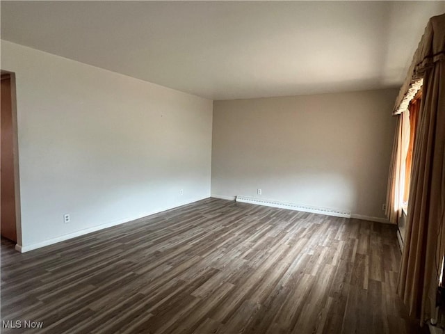 213 Kenmore Ave SE, Warren, OH 44483 - unfurnished room with a baseboard heating unit, dark wood-style flooring, and baseboards