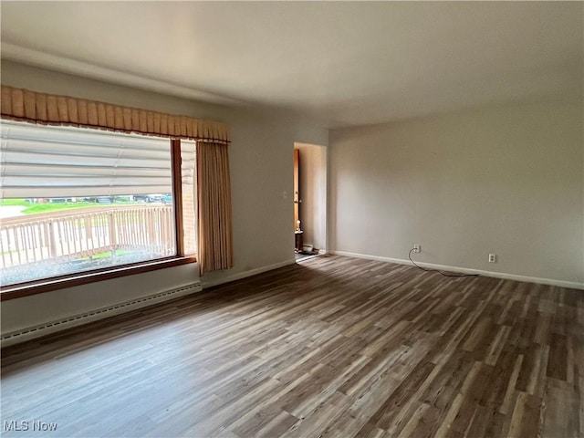 213 Kenmore Ave SE, Warren, OH 44483 - empty room with a baseboard radiator, wood finished floors, and baseboards